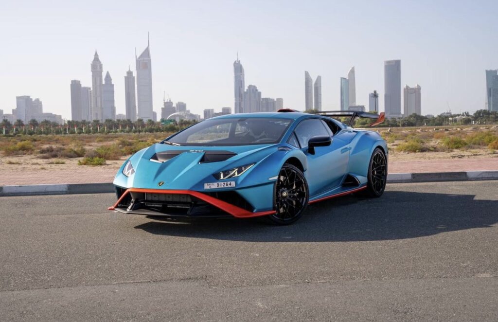 Experience the Lamborghini Huracán STO in eye-catching sky blue and orange. A street-legal race car with a 640 hp V10 engine and precision handling. Rent it today with LuxeRidez Dubai.