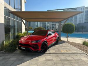 Red Lamborghini Urus 2024 luxury SUV parked in Dubai marina
