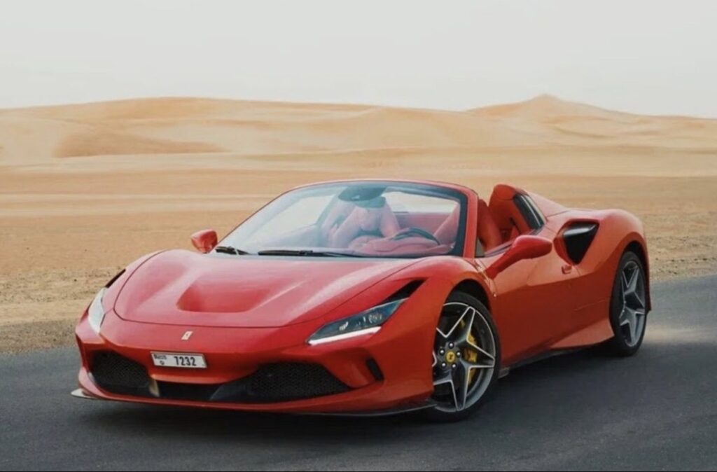 Luxury Ferrari F8 Tributo 2024 red convertible parked in Dubai desert with sporty design and V8 performance