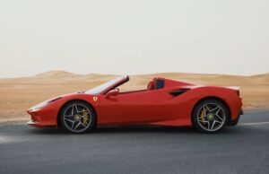 Luxury Ferrari F8 Tributo 2024 red convertible parked in Dubai desert with sporty design and V8 performance