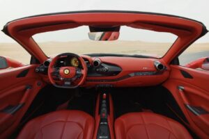 Luxury Ferrari F8 Tributo 2024 red convertible parked in Dubai desert with sporty design and V8 performance