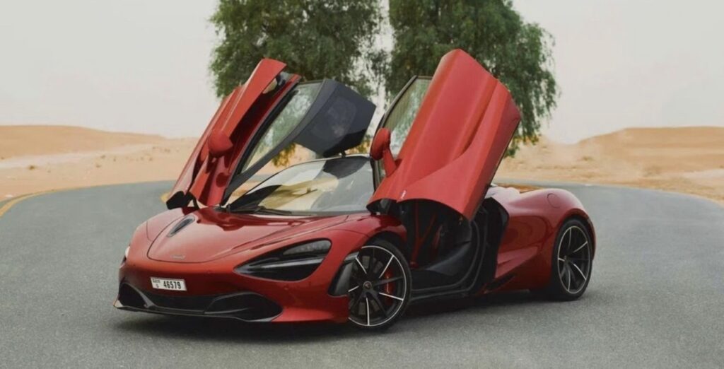 Red McLaren 720S 2024 with butterfly doors open in desert road