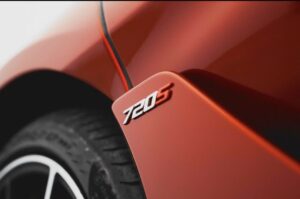 Red McLaren 720S 2024 with butterfly doors open in desert road