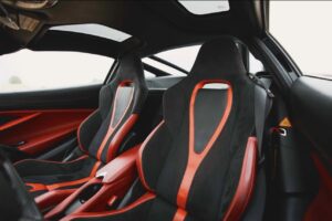 Red McLaren 720S 2024 with butterfly doors open in desert road