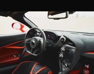 Red McLaren 720S 2024 with butterfly doors open in desert road