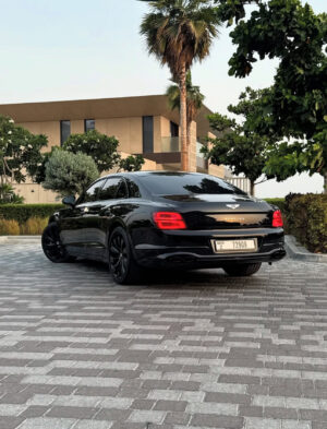 Black Bentley Flying Spur luxury sedan front view in Dubai