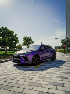 Purple and black Lamborghini Urus Mansory edition front angle view